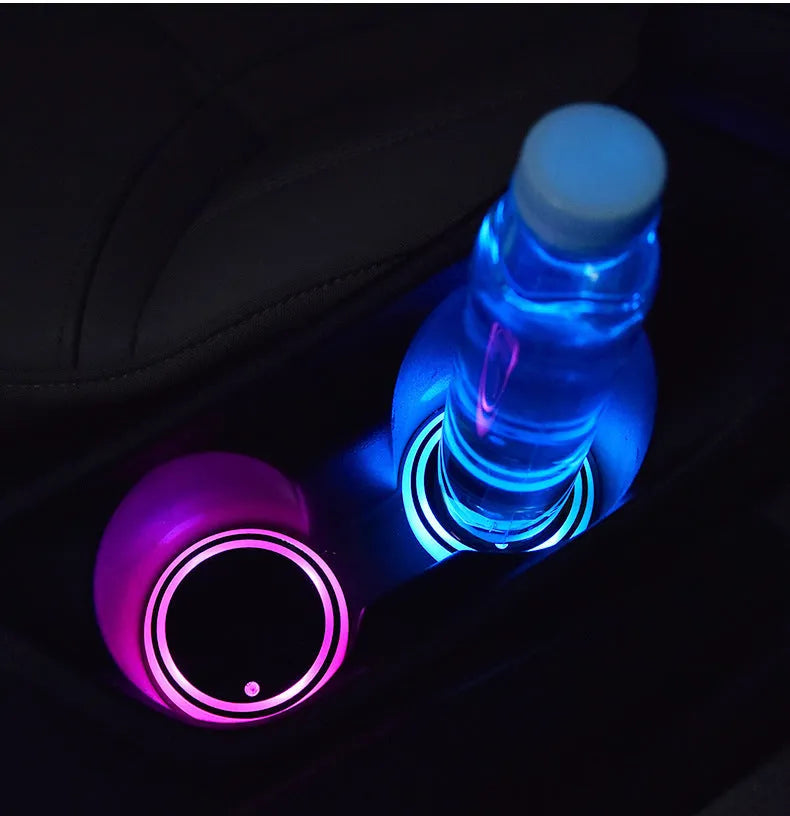 Colourful LED light-up coaster for car cup holder showing multiple light colours on a dark surface.