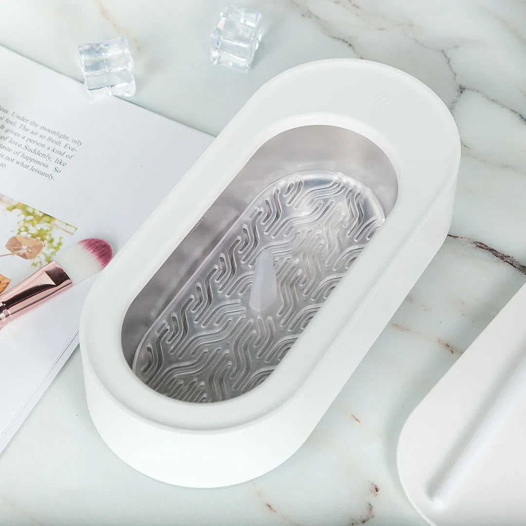 White portable ultrasonic cleaning machine with digital display and stainless steel tank.