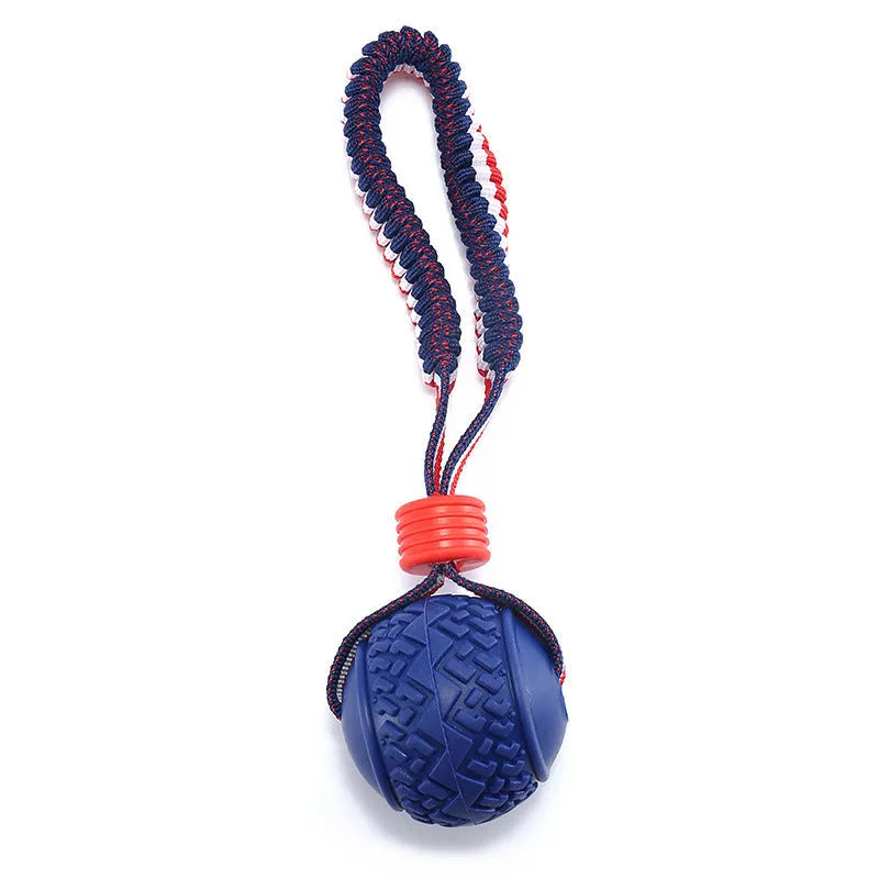 Red rubber dog ball with rope attachment for tug of war and teeth cleaning