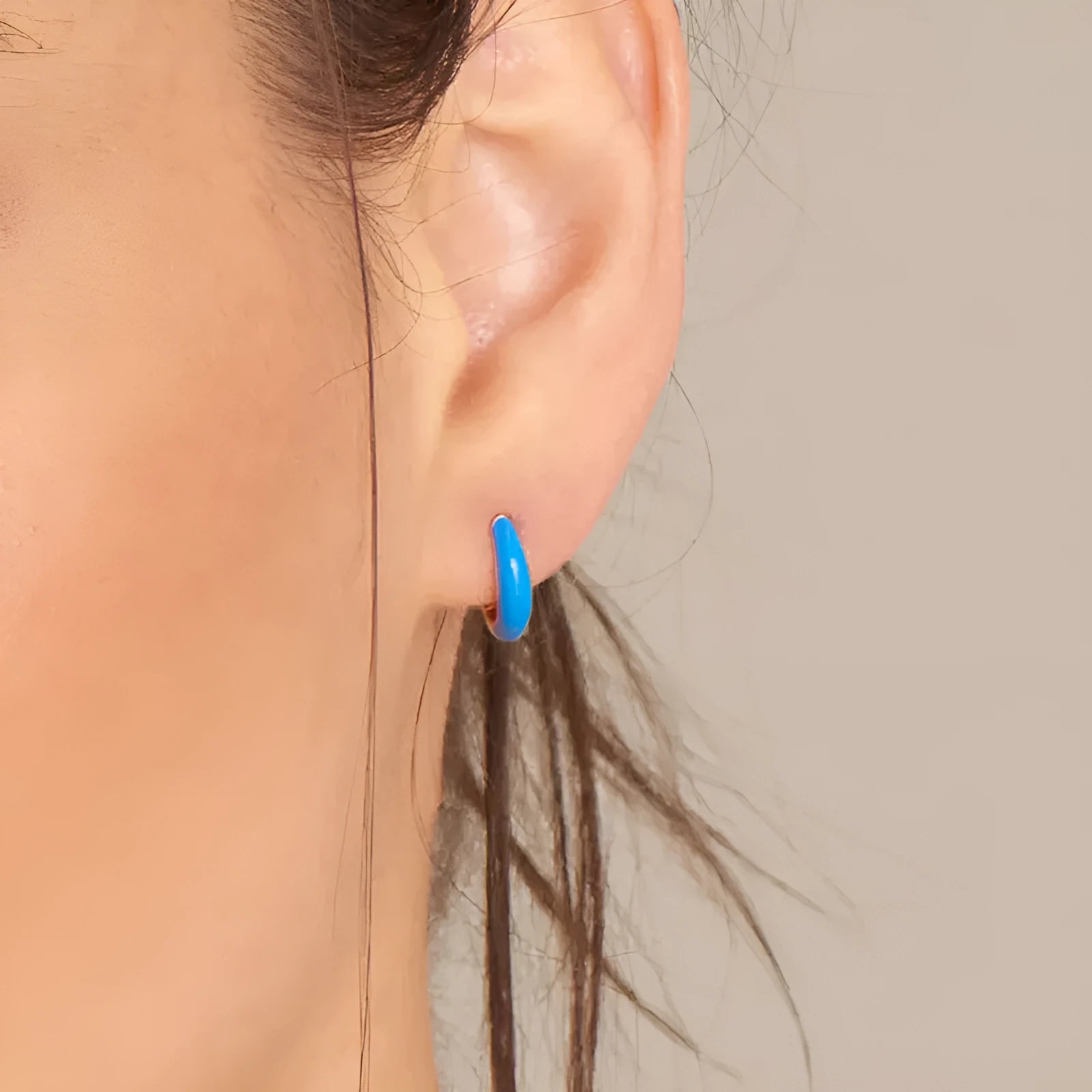 A pair of colourful epoxy oval curved earrings made from silver needle copper wire in a geometric U-shape design.