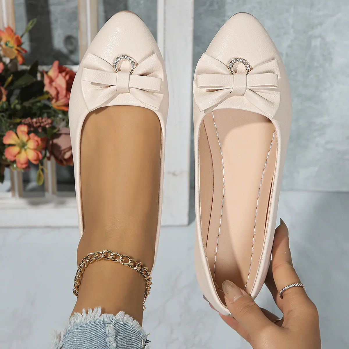 Women's beige casual flat shoes with a bowknot detail, shallow mouth, round toe, and flat rubber sole.