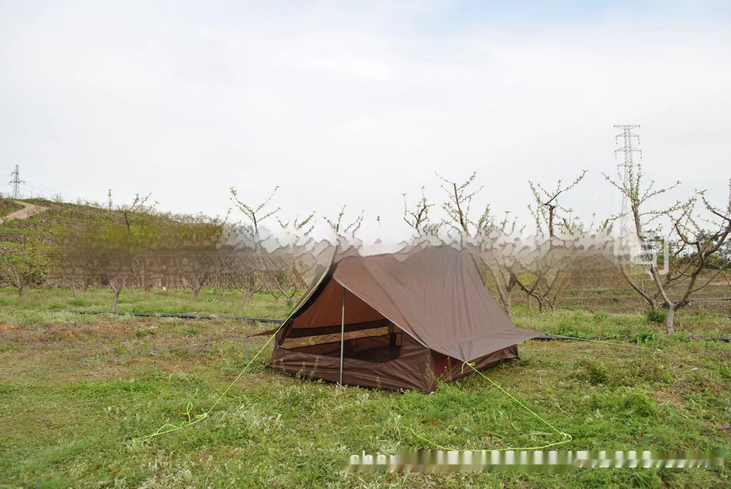 Brown and white pole-free A-line cabin tent set up with hiking canes, showing spacious interior