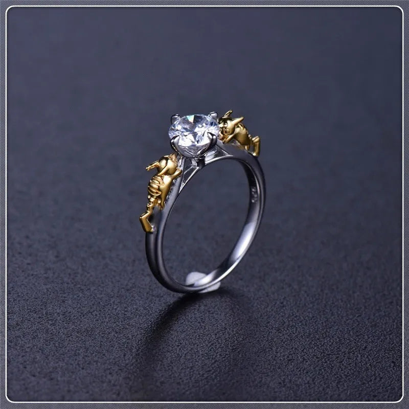 Copper crown crystal ring in black gold colour on a neutral background.