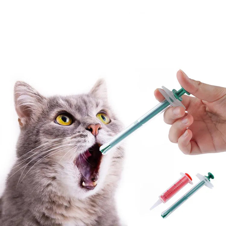 Two white pet pill shooter dispensers with soft silicone tips and push rods for administering tablets to cats and dogs.