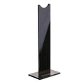 A black or pink detachable headphone stand for head-mounted gaming headsets on a desk.
