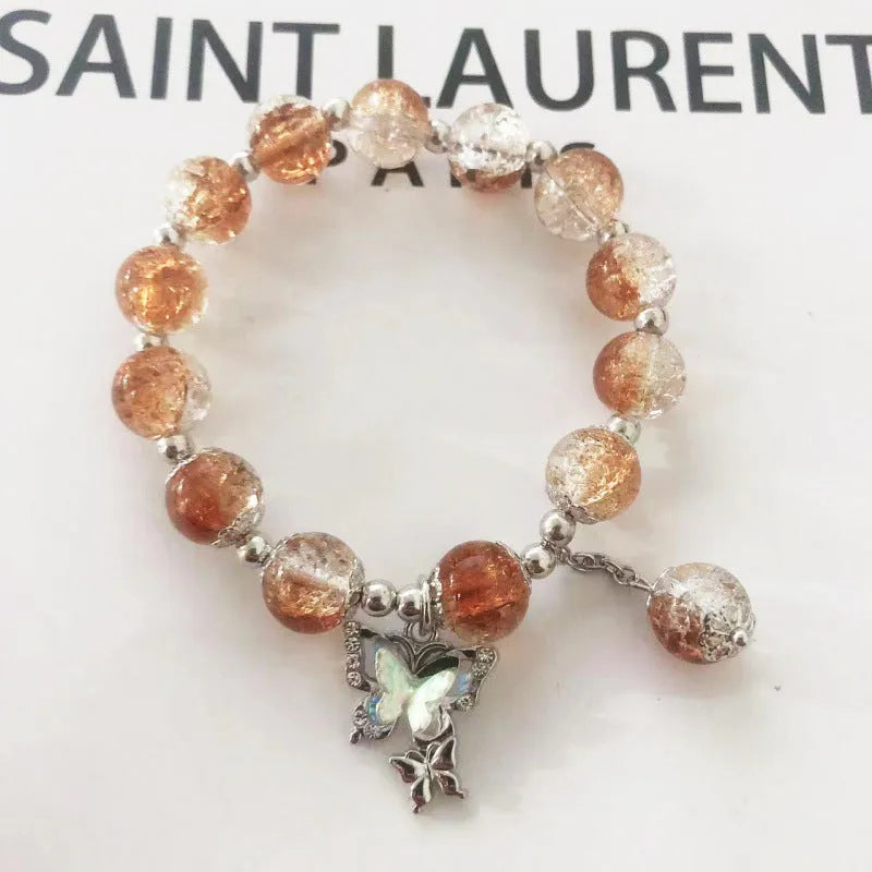 Chinese style handmade glass bead bracelet with bamboo joint elements on a white background.