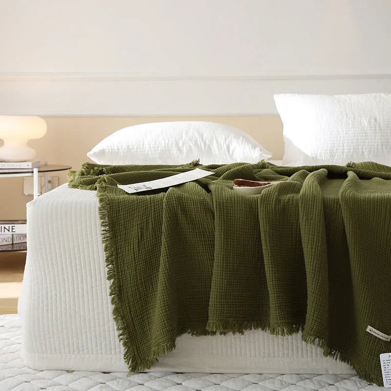 Four-layer cotton gauze blanket with tassel trim in avocado green colour