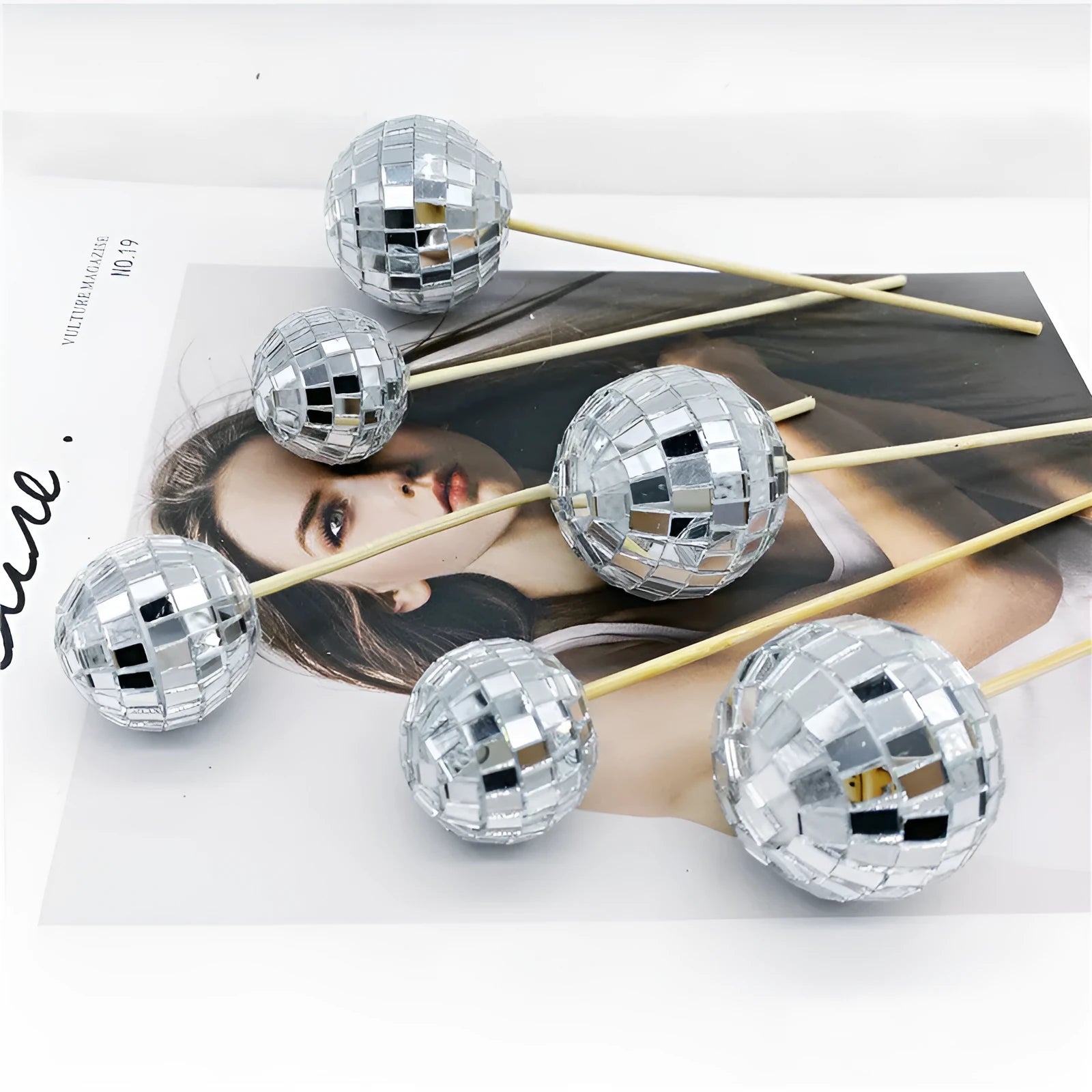 Glass disco ball cake decoration with wooden stick on a birthday cake