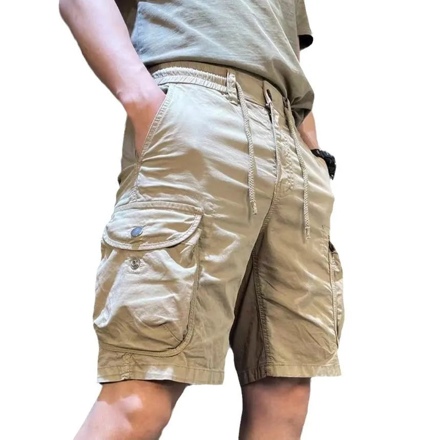 A pair of loose-fitting, straight-leg casual overalls in a khaki colour with multiple visible pockets.