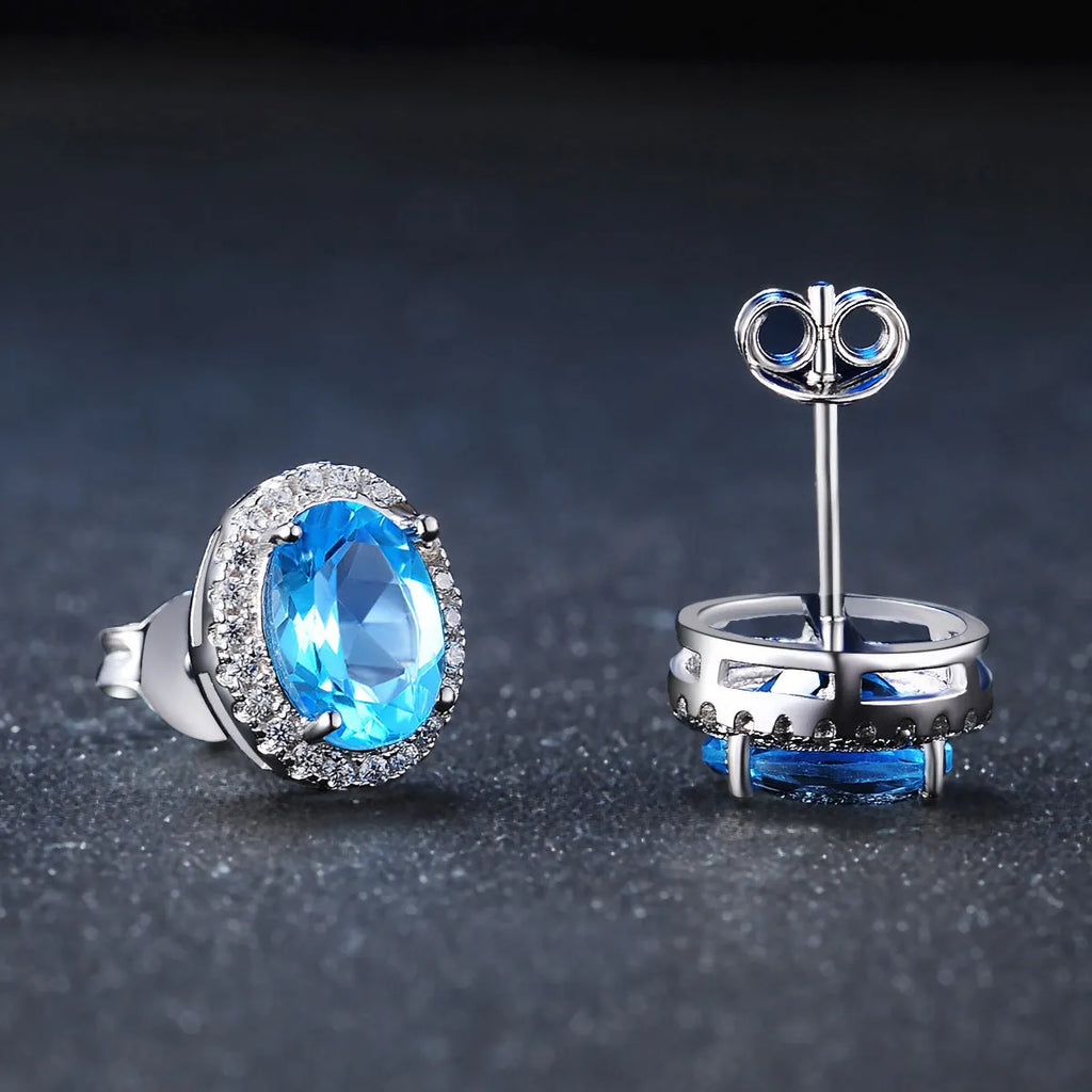 925 sterling silver jewellery set with blue topaz gems in geometric design including earrings, ring, necklace and pendant