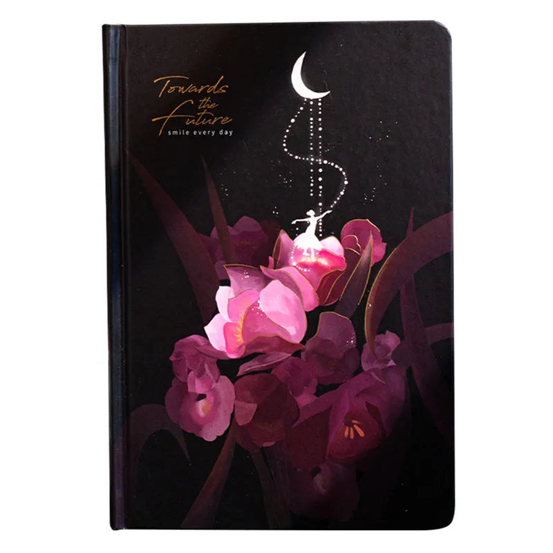 A5 notebook with luminous cover in blue, gold, light blue, or purple, open to show pages for colour illustration.