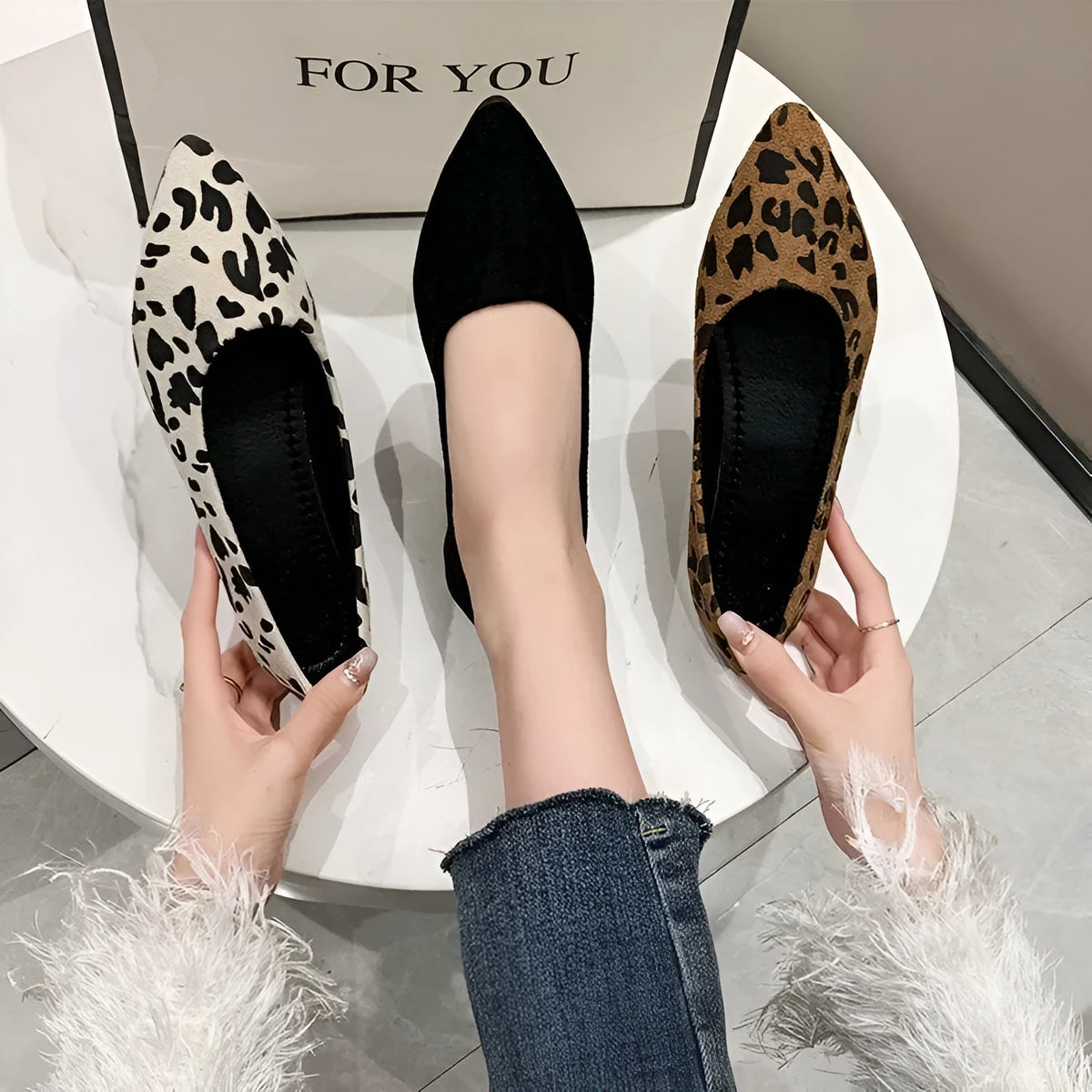 Women's leopard print flat pointed toe pumps with low heel on a rubber sole.