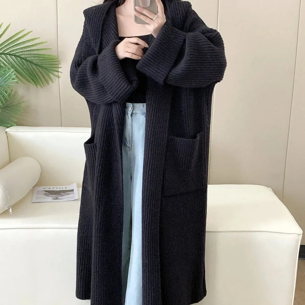 Women's loose grey hooded cardigan coat with raglan sleeves on hanger