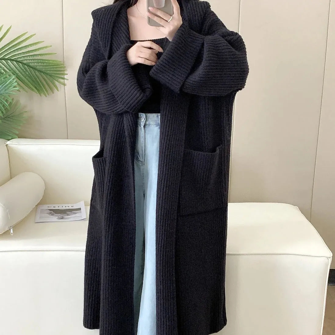 Women's loose grey hooded cardigan coat with raglan sleeves on hanger