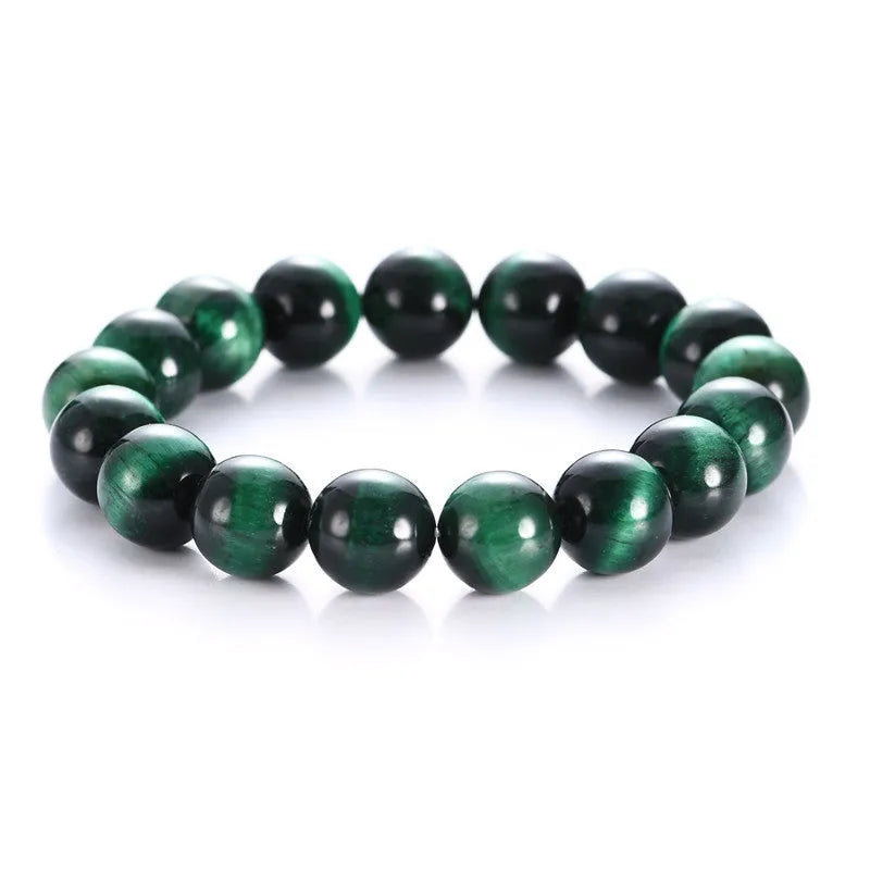 Green polished Tiger Eye stone bracelet with geometry beads on a wrist.