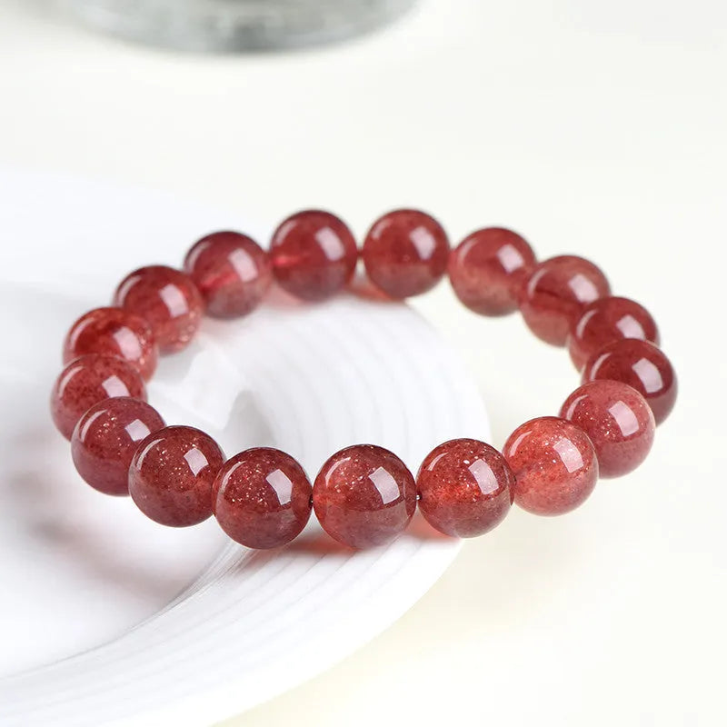 Natural strawberry quartz bracelet with geometric cherry red beads showing a starlight sparkle.