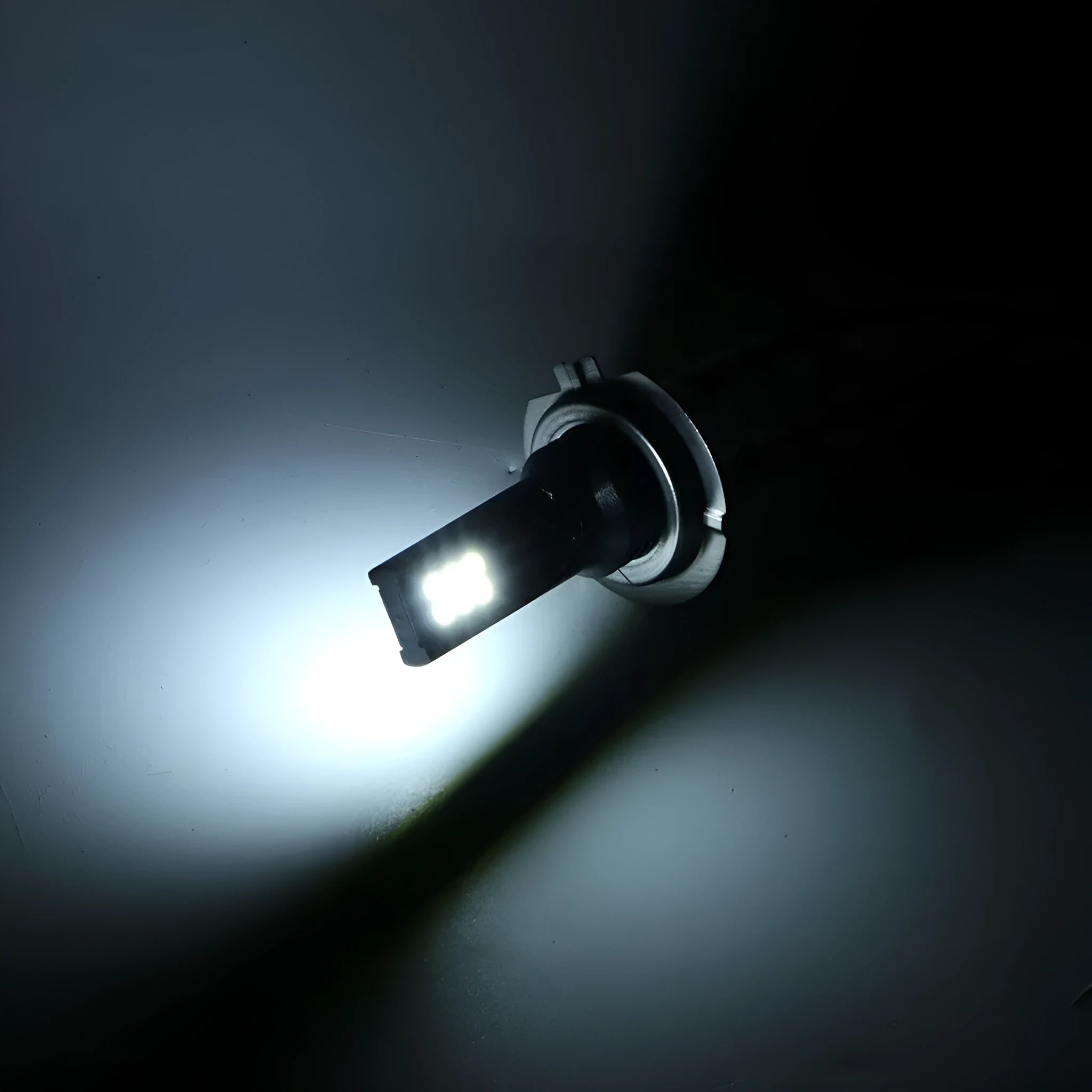 Close-up of a white aluminium H7 LED fog light with 12 visible SMD chips.