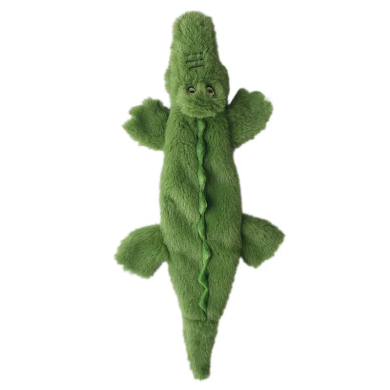 Green crocodile-shaped plush dog toy with no stuffing, squeaker in head, and crinkle paper tail