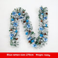 Flocked PVC rattan vine Christmas garland decoration in a festive colour, draped over a mantelpiece.