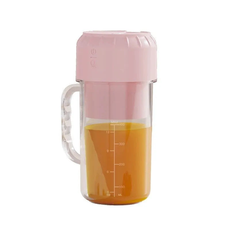 Portable mini juicer in avocado green with USB cable and multiple blade options.
