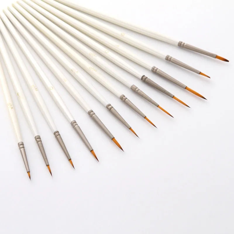 12 Pearl White artist brushes with nylon wool bristles and solid wood handles arranged by size.