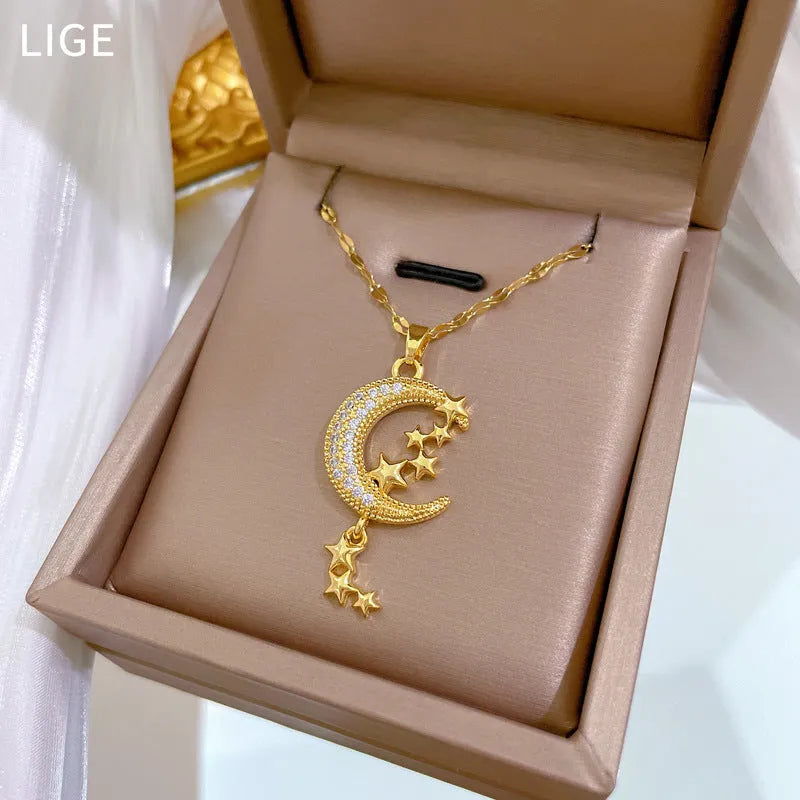 Geometric moon pendant necklace with diamond accents and tassel on stainless steel chain