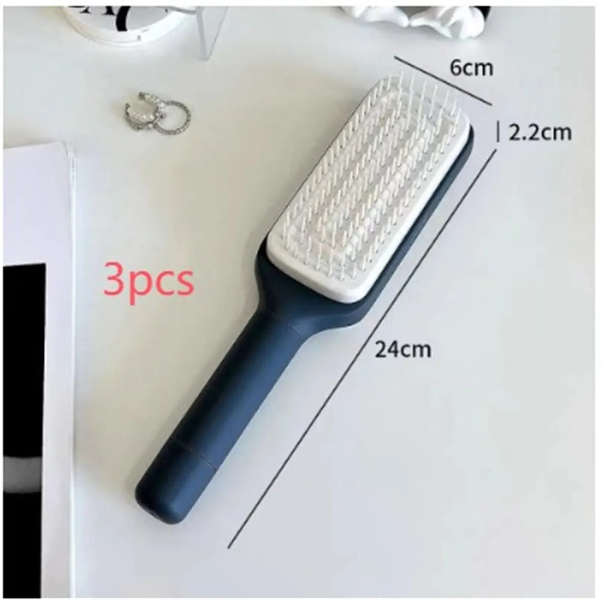 Self-cleaning hairbrush with rotating handle in Roland purple colour showing anti-static teeth and massage comb function