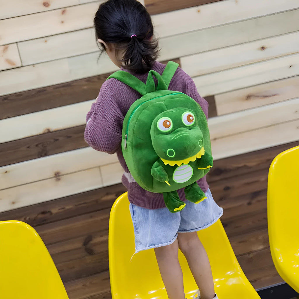Dinosaur plush backpack for children in blue with embroidered design and soft handle