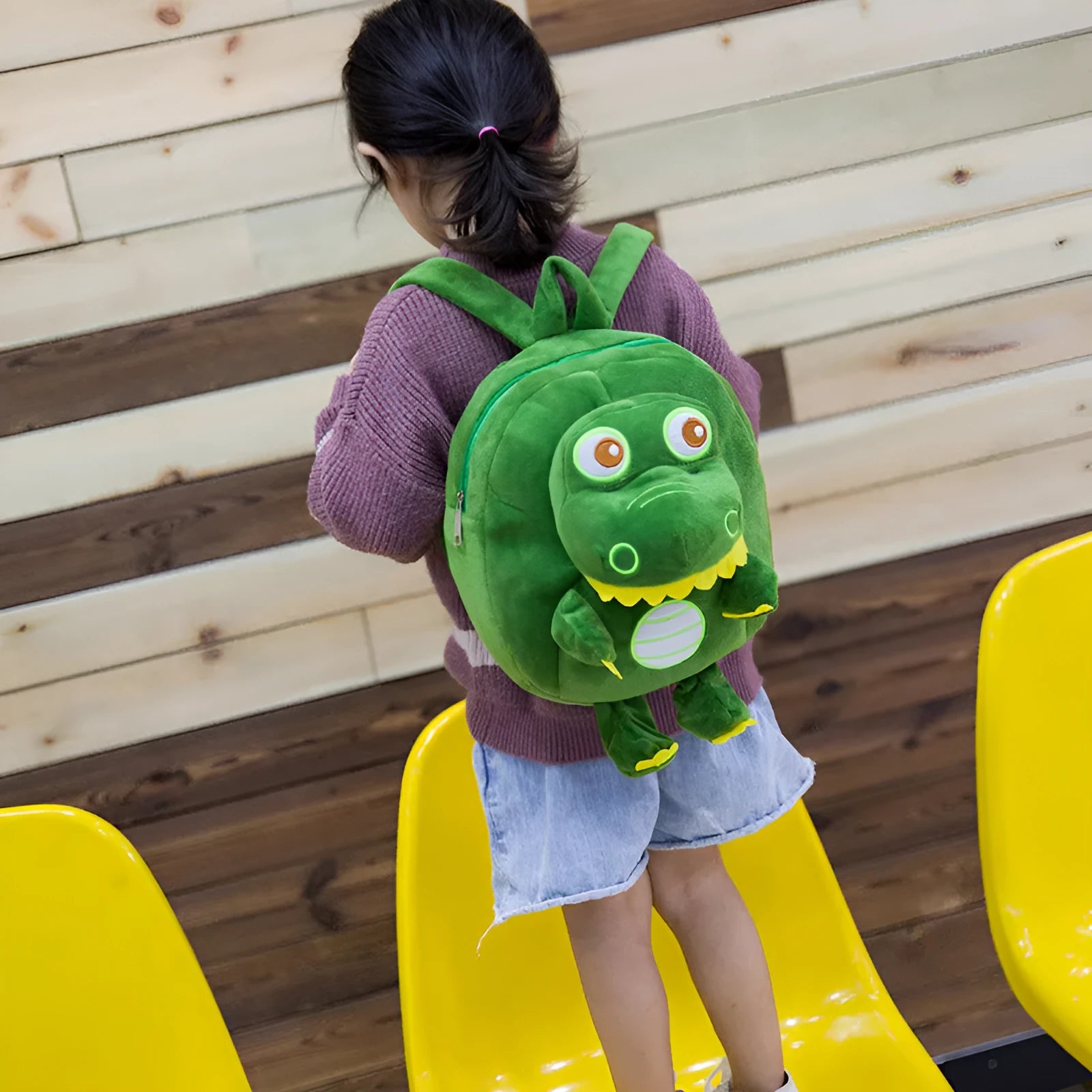 Dinosaur plush backpack for children in blue with embroidered design and soft handle