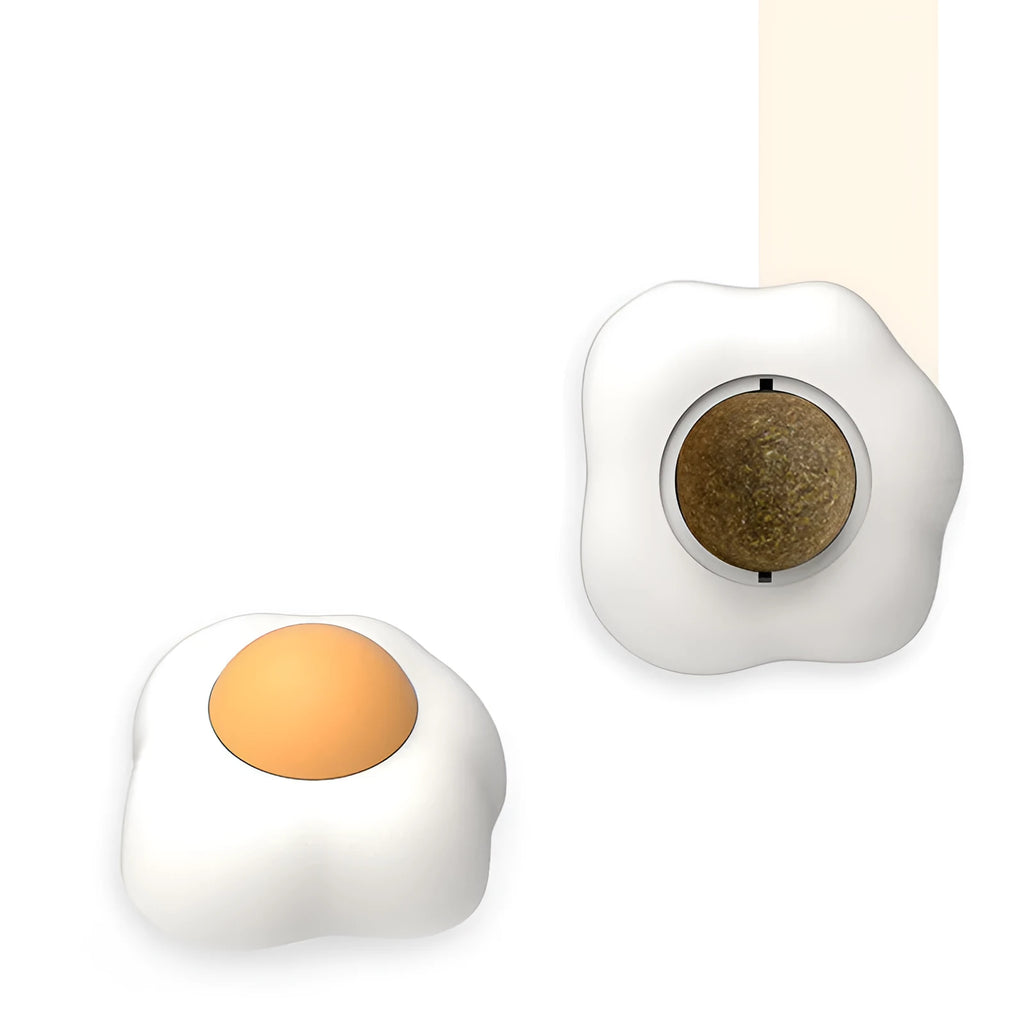 Interactive catnip ball toy with adhesive backing for walls, available in fried egg and poached egg designs