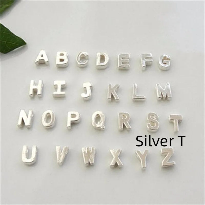 Gold and silver alloy peach heart shaped letter pendant necklace charm on a chain.