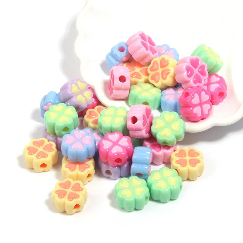 Acrylic clover craft beads with frosted finish in mixed colours including pink, blue and green