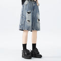 Loose-fit denim shorts with a washed fabric finish and ripped, distressed detailing on the legs.
