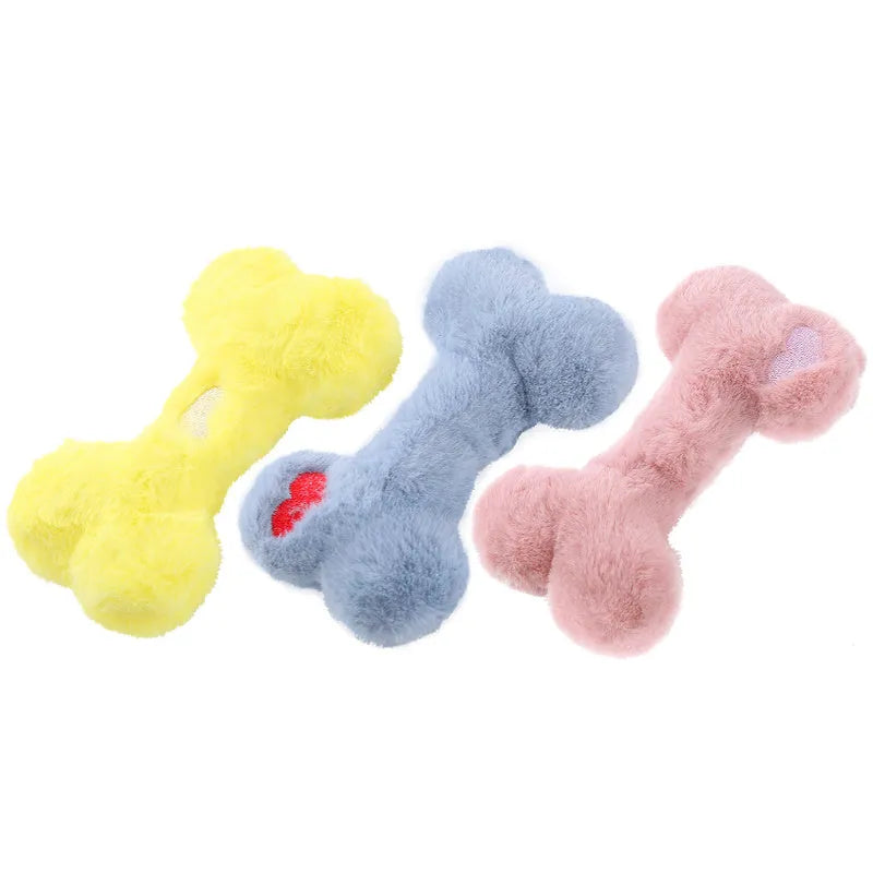 Blue, pink and yellow bone-shaped plush dog toys with squeaker for interactive play