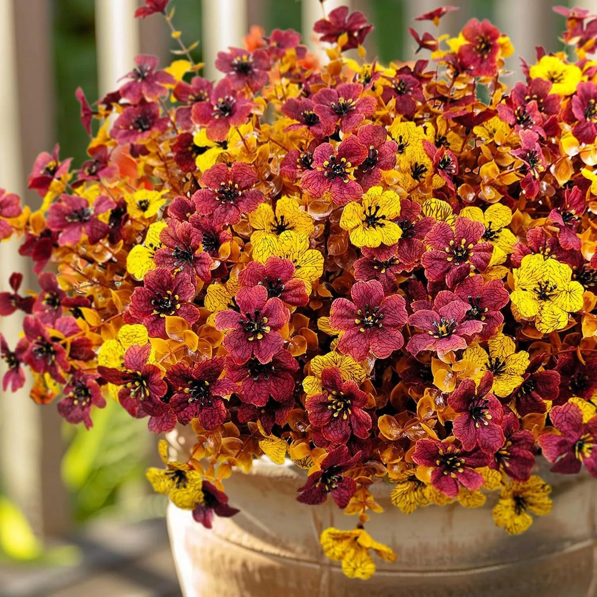 Artificial silk flower bouquet in autumn colours on a plastic stem for home and event decoration.