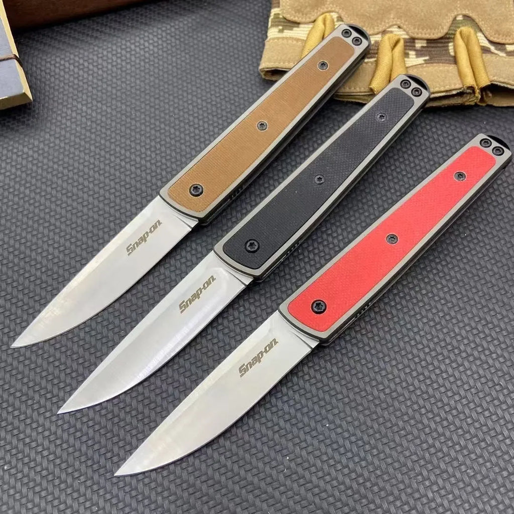 CRKT 7190 folding fruit knife showing blade and handle with colour options of black, brown, and red