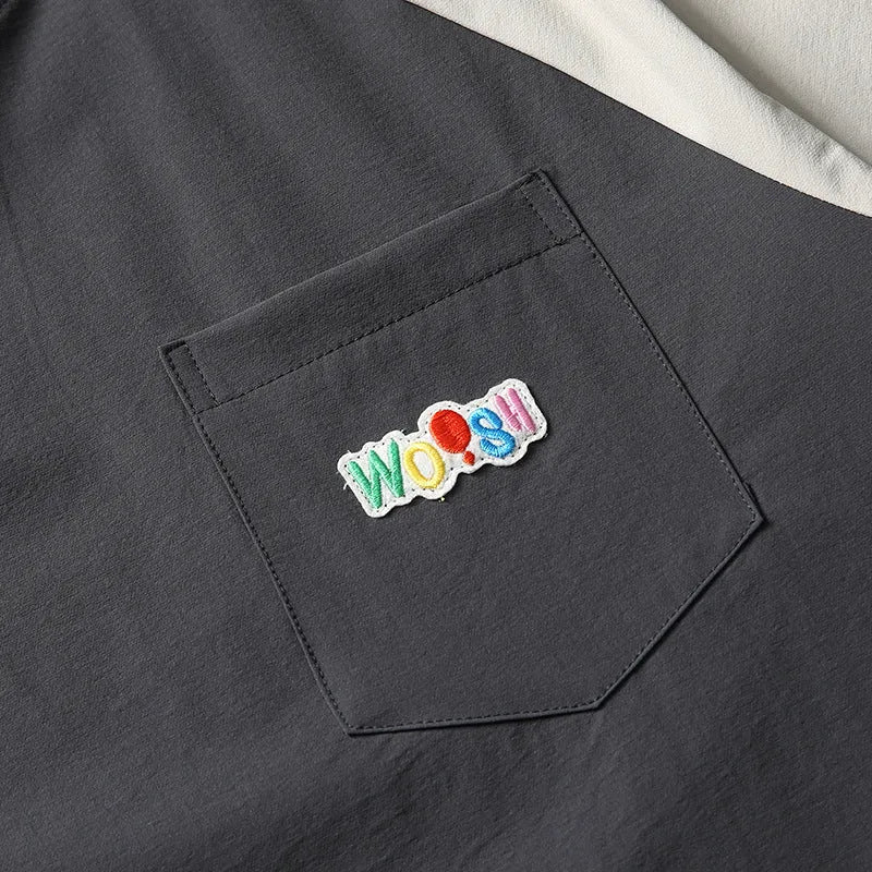 Dark grey men's loose fit t-shirt with light coloured contrast raglan sleeves.