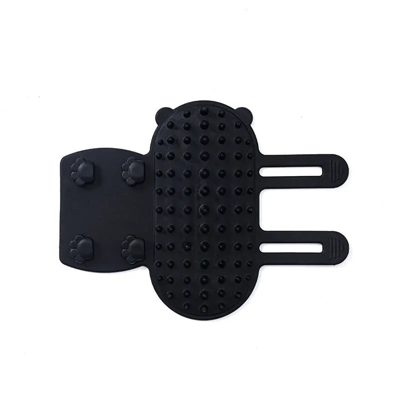 Silicone wall-mounted cat grooming brush with comb teeth and adjustable strap for table legs.