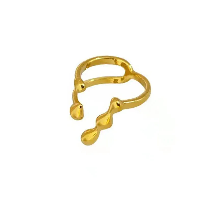 Brass opening ring with circle and sphere design in gold finish on finger