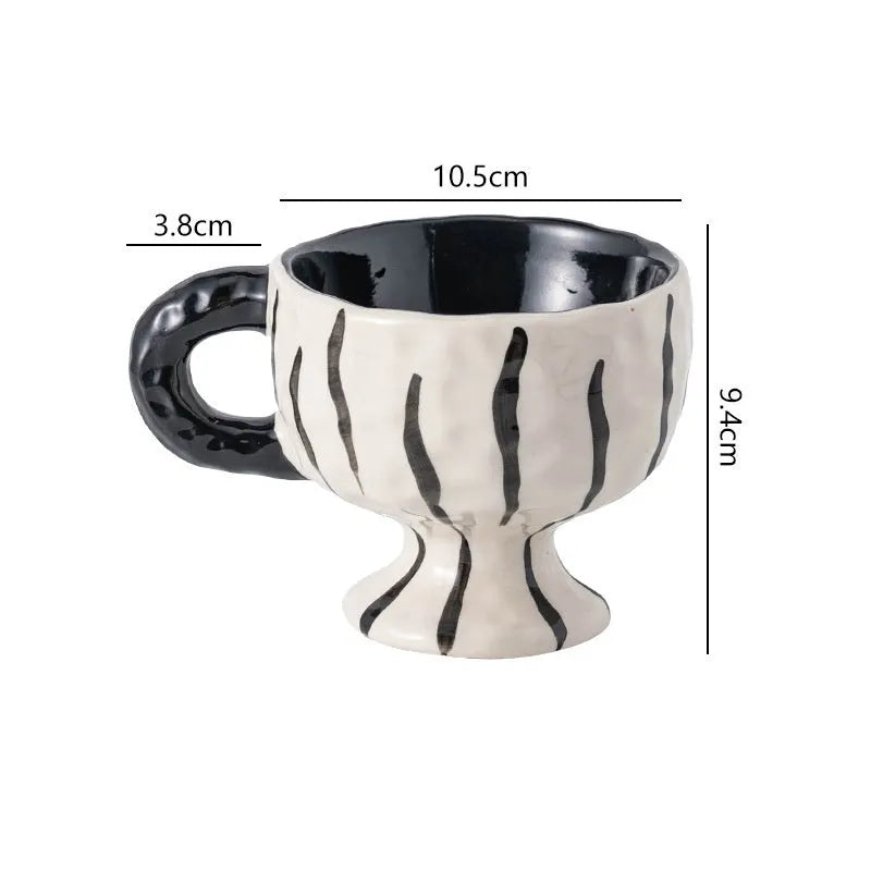 Hand-pinched irregular ceramic mug in a solid colour, shown from the side to display its unique shape.