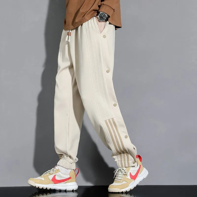 Men's loose fit ankle-tied sports pants in black with drawstring waist and elastic cuffs