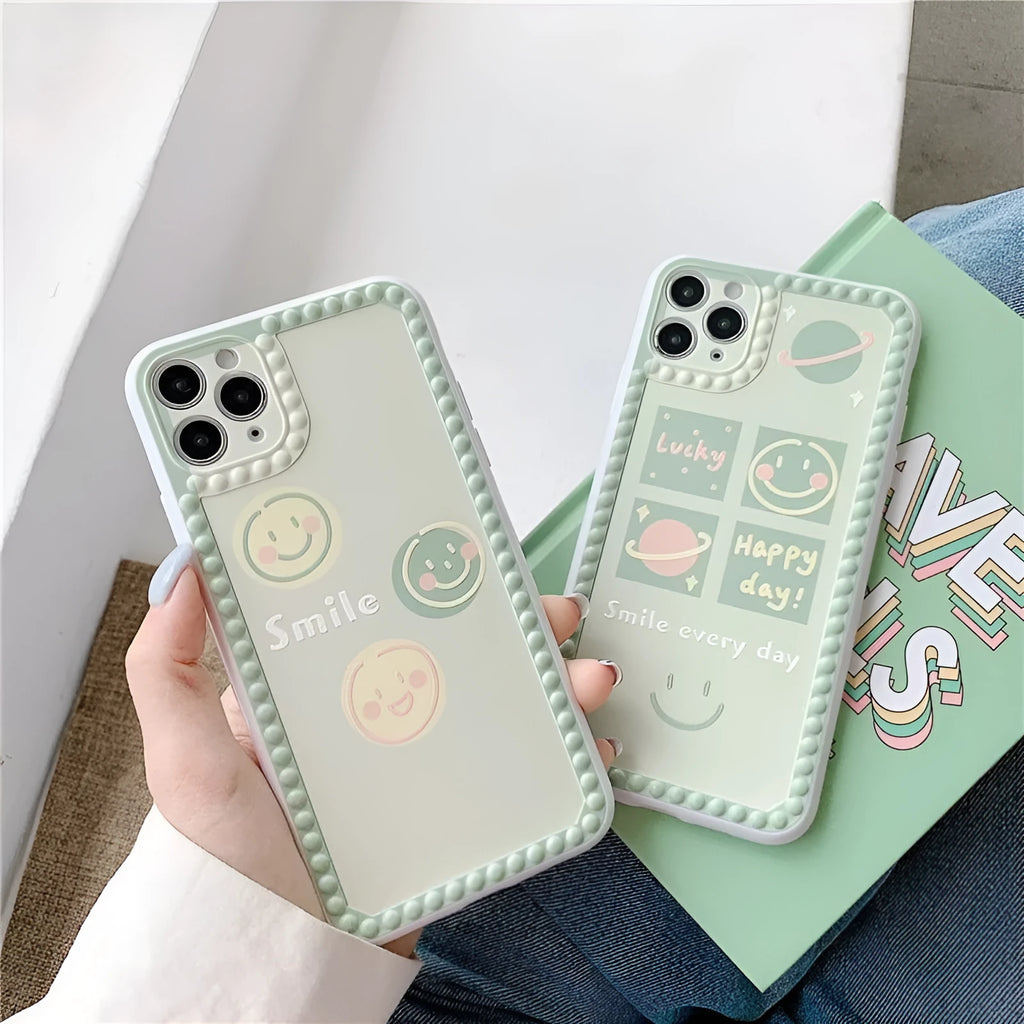 Green TPU iPhone case with geometric smiley face and polka dot design on a simple back cover.