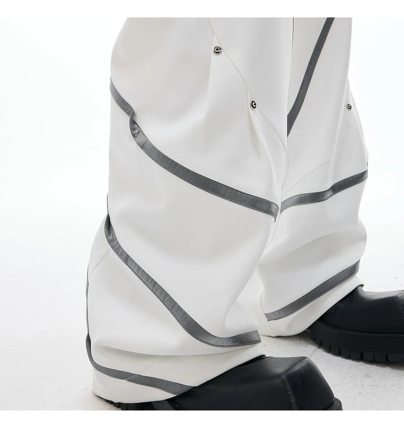 Men's trousers with deconstructed cut, metal striped rivets on pleats, and polyester fabric in black bottom colour