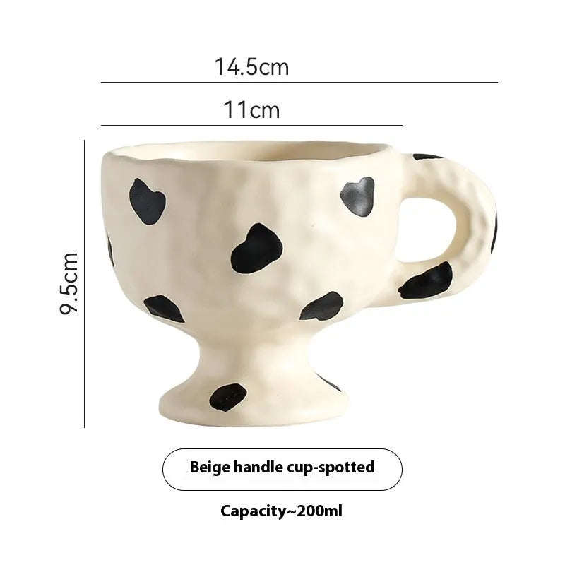 Hand-pinched irregular ceramic mug in a solid colour, shown from the side to display its unique shape.