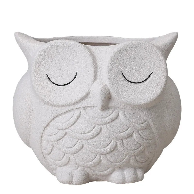 Handmade frosted ceramic owl planter for small succulents, shown in light pink.