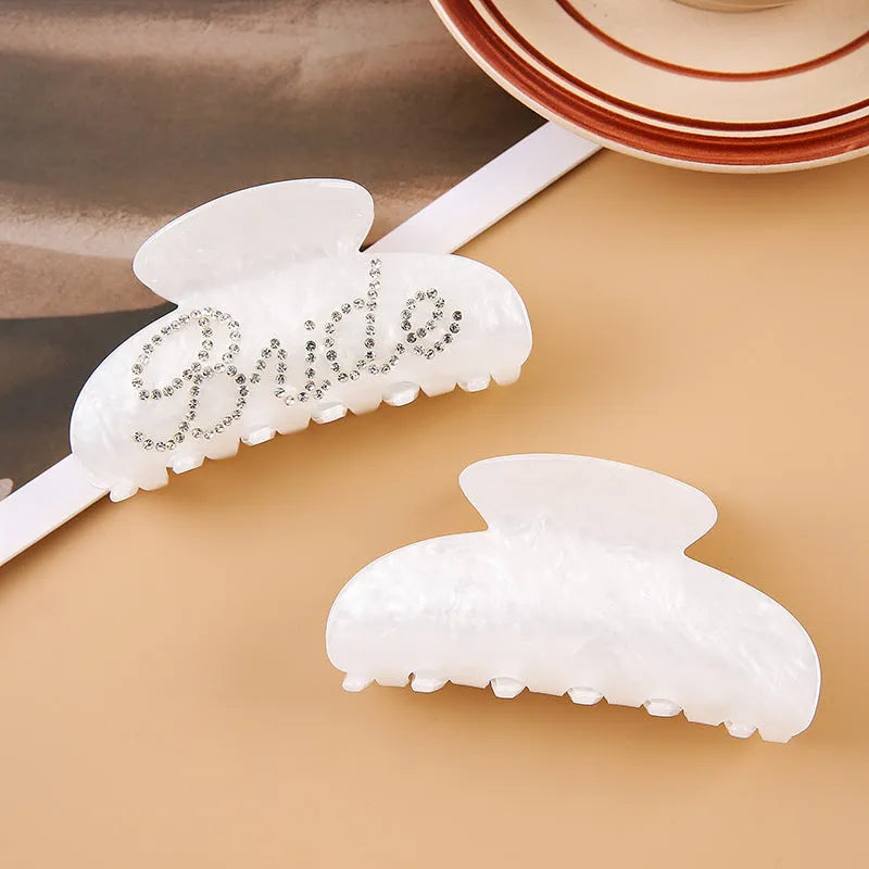Pink acrylic hair clip with shark shape and diamond spot drilling, 10cm long with spring-clip back.
