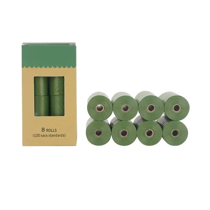 Roll of green EPI degradable dog poop bags next to a white dispenser on a table.