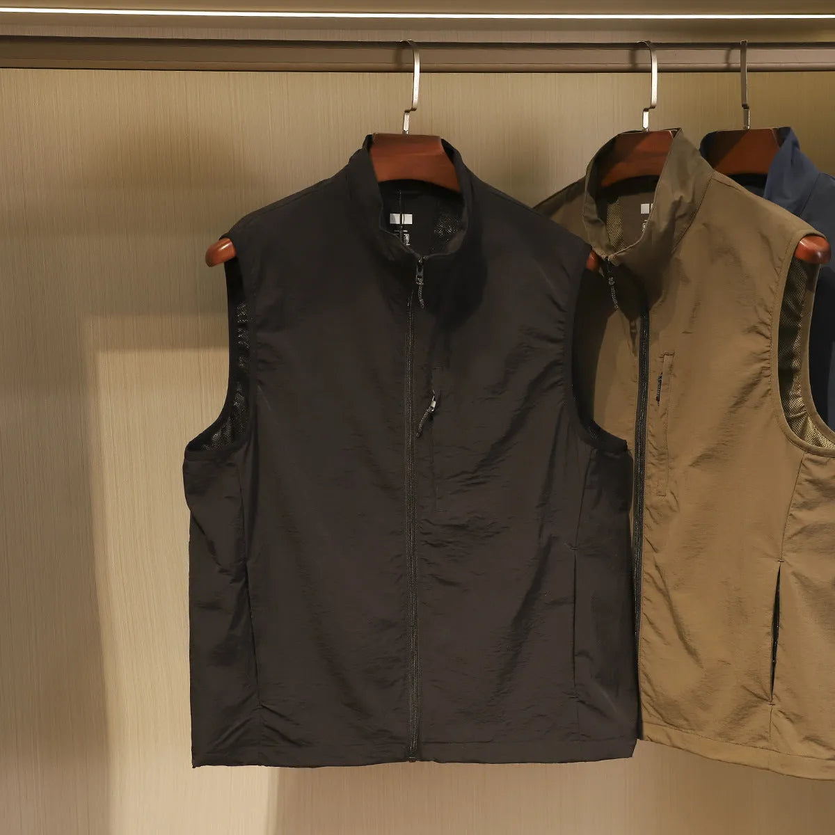 Men's straight-cut nylon vest in Army Green with side seam pockets.