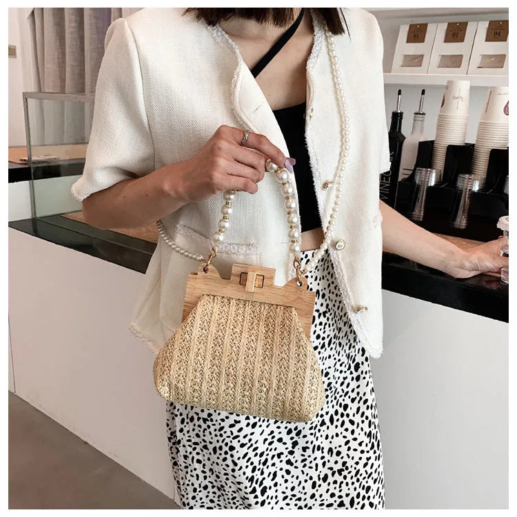 Women's straw shoulder bag with pearl chain detail in horizontal square shape