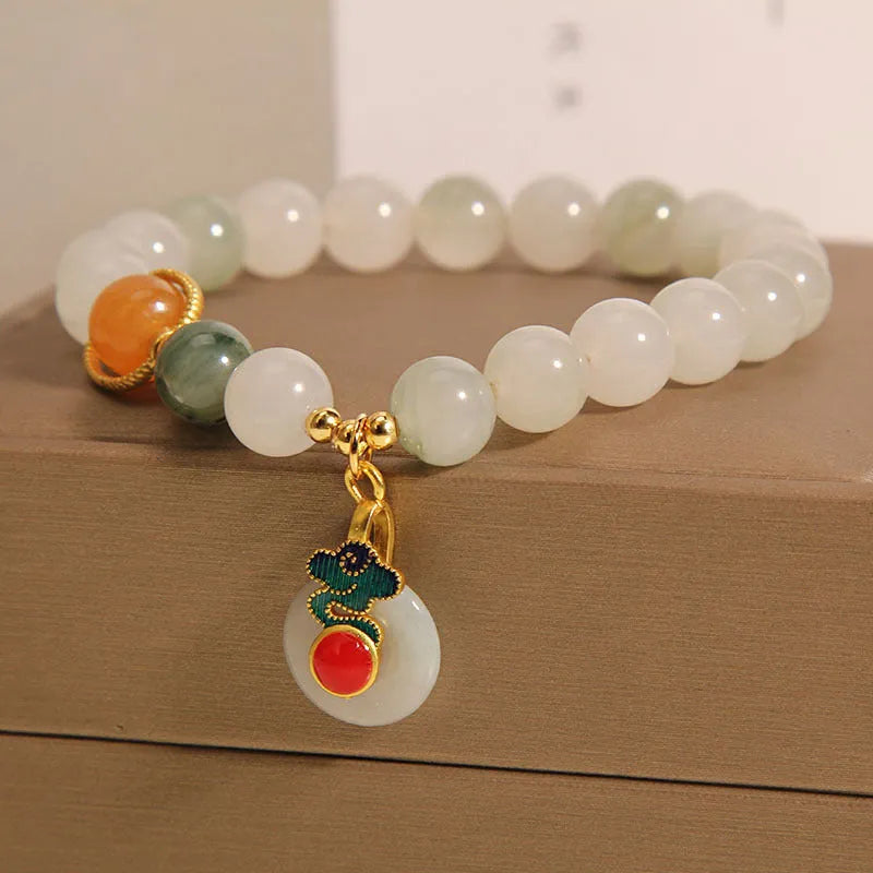 Women's ice jade crystal bracelet with xiangyun peace buckle and pearl accents on a retro-style chain.